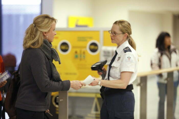 Screening agents helping out passengers going through the airport in Canada during the busy winter season 