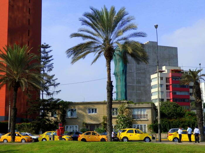 Yellow taxis in Lima, Peru parked outside in a row 