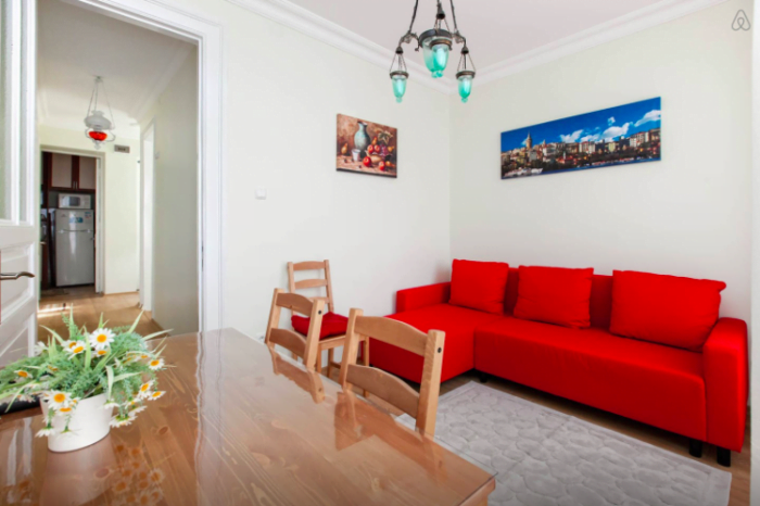 Using AirBnB in Istanbul, Turkey with a beautiful red sofa and large spacious table for working online 