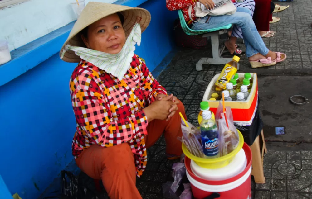 Vietnamese lady selling drinks on the streets of Saigon, Vietnam in Ho Chi Minh City 
