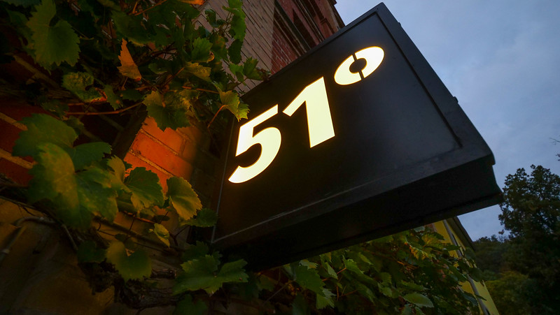 51° Restaurant & Weinbar in Freyburg, Germany views of the signboard outside with nearby ivy in all directions 
