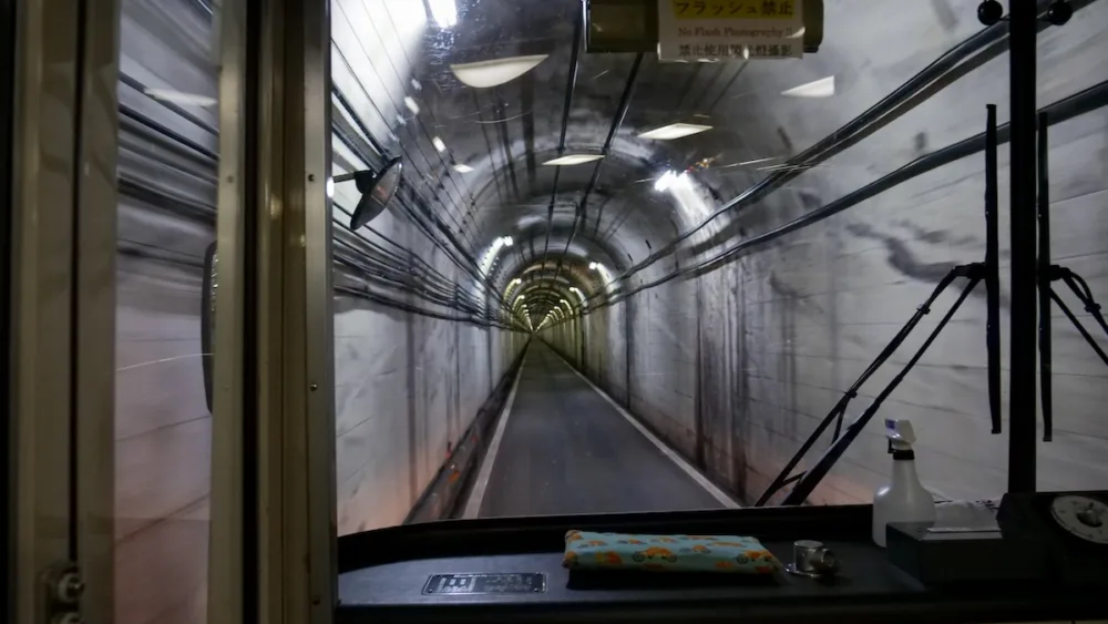 The Tateyama Tunnel Trolley Bus travels through a tunnel that crosses Mount Tateyama 