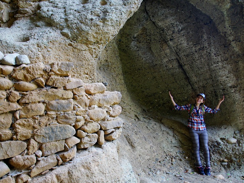 A cave that was turned into a jail with That Backpacker Audrey Bergner standing outside of the entrance in Meteora, Greece 