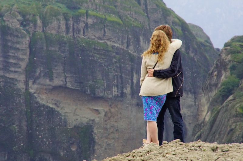 A couple enjoying a hug whilst admiring the stunning landscapes in Meteora, Greece A couple enjoying a hug whilst admiring the stunning landscapes in Meteora, Greece