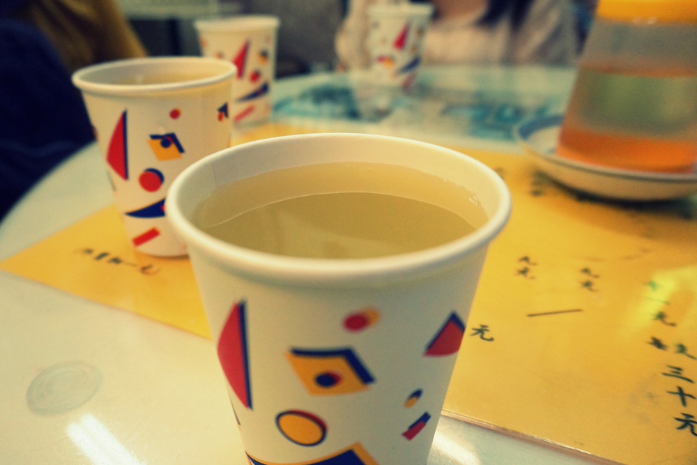 A cup of super refreshing and sweet sugar cane juice in Hong Kong served in a paper cup without a lid