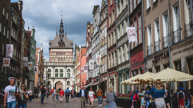 A guide to some of the best things to do in Gdansk with this bustling scene of pedestrians enjoying the city centre in Poland
