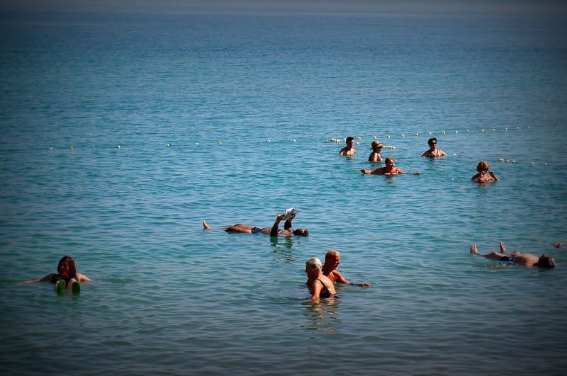 A man relaxing by reading a magazine while floating in the Dead Sea in Israel