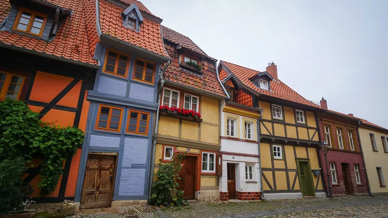 A row of distinctly colourful half-timbered buildings in Quedlinburg A row of distinctly colourful half-timbered buildings in Quedlinburg