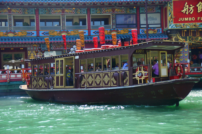 A sampan boat ride in Aberdeen area of Hong Kong Island with an elaborate decorations on the outside of the vessel 
