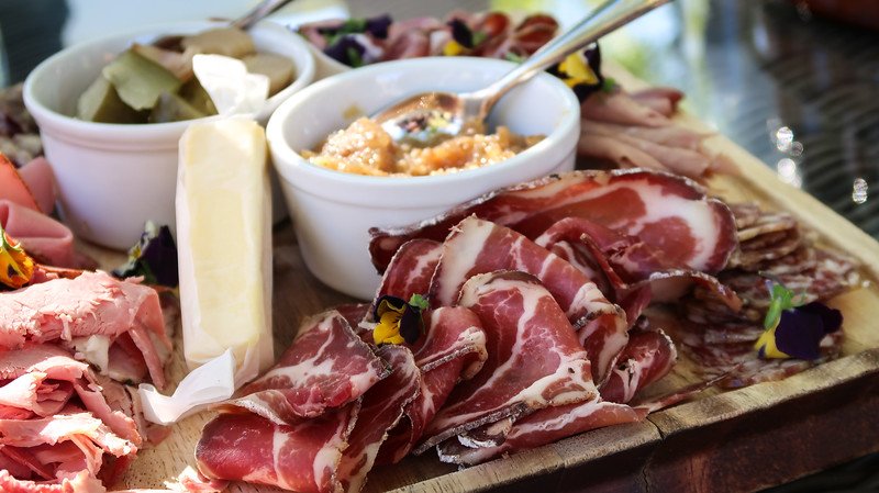 A vineyard brunch with various deli meats and spread and cheeses on offer in Stellenbosch, South Africa 