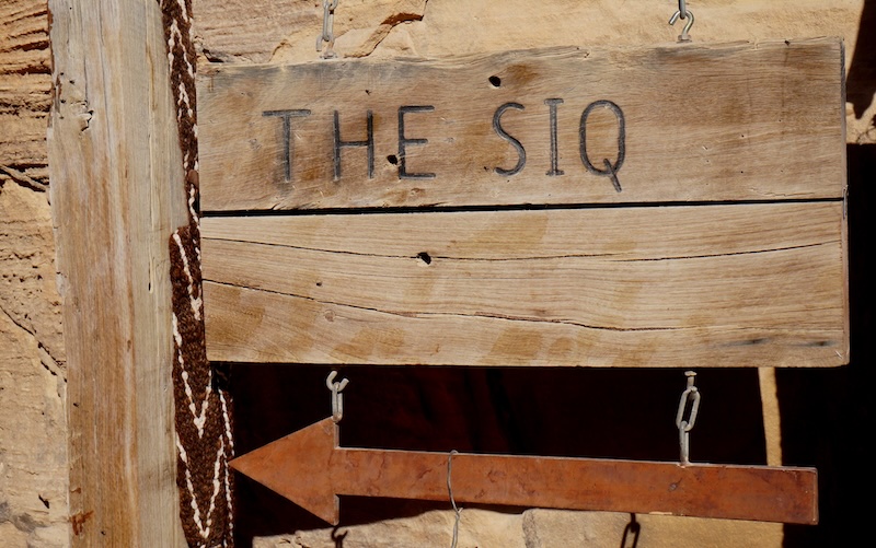 A wooden sign pointing to The Siq in Petra, Jordan 