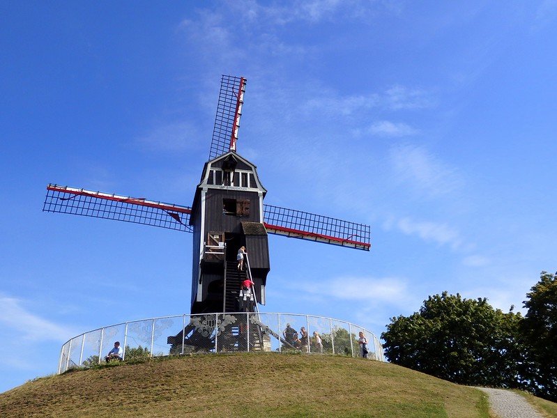 Active windmill open to visitors to climb up and down the staircase in Bruges, Belgium Active windmill open to visitors to climb up and down the staircase in Bruges, Belgium