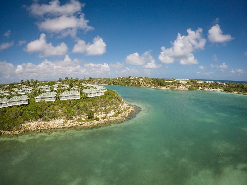 Aerial shot of Verandah Resort and Spa in Antigua with buildings, clouds and water Aerial shot of Verandah Resort and Spa in Antigua with buildings, clouds and water