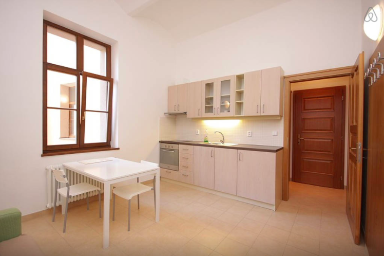 Airbnb table and kitchen area views from our apartment in Prague, Czechia with basic amenities but everything we needed for our trip