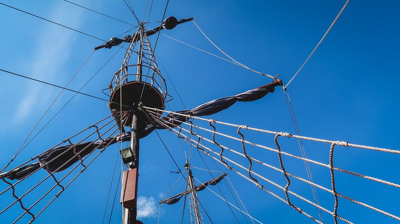 All aboard the pirate ship with details of the boat from a low vantage point looking upwards to the sky in Sopot, Poland