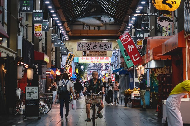 Another place to add to your Osaka travel itinerary is Kuromon Market which is a bustling hive of activity with pedestrians and bicyclers alike