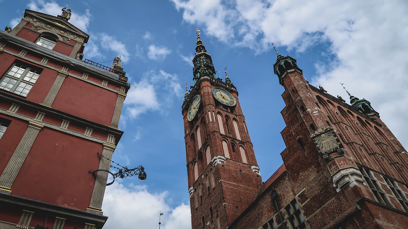 Architecture in Gdansk with distinct clock towers and archways in an otherwise brick facade in Poland