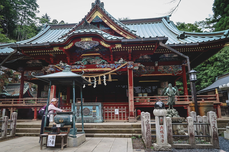 Attractions atop Mount Takao where visitors are burning incense candles and presenting other offerings along the way 