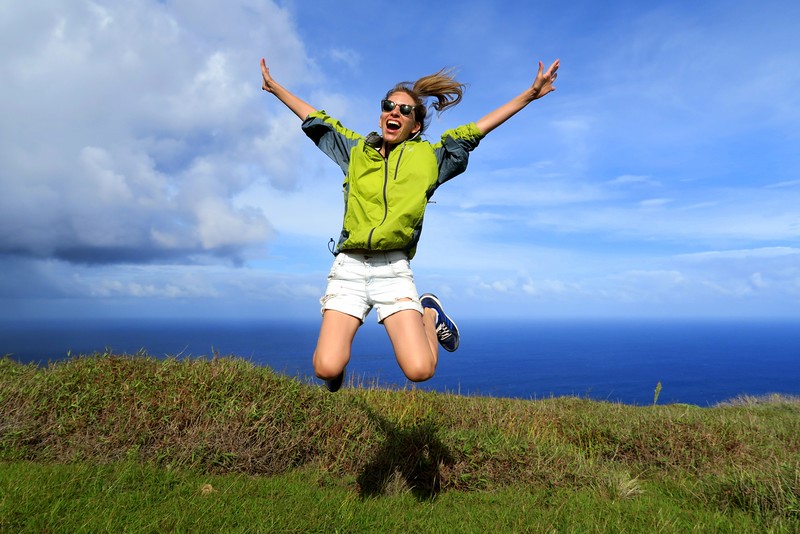 Audrey Bergner, Founder of That Backpacker, jumping for joy while exploring the landscapes of Rapa Nui (Easter Island), Chile.