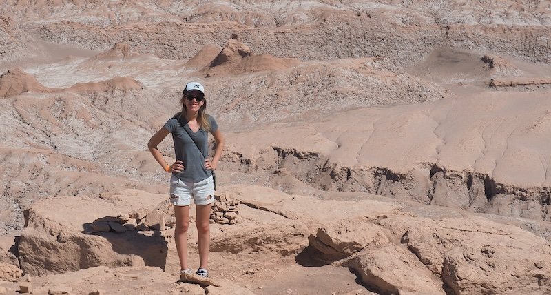 That Backpacker Audrey Bergner standing on the rocky cliffs of Valle de la Luna in Chile’s Atacama Desert, enjoying panoramic desert views That Backpacker Audrey Bergner standing on the rocky cliffs of Valle de la Luna in Chile’s Atacama Desert, enjoying panoramic desert views