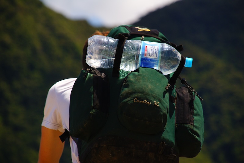 Backpacker with huge water visiting Machu Picchu, Peru Backpacker with huge water visiting Machu Picchu, Peru