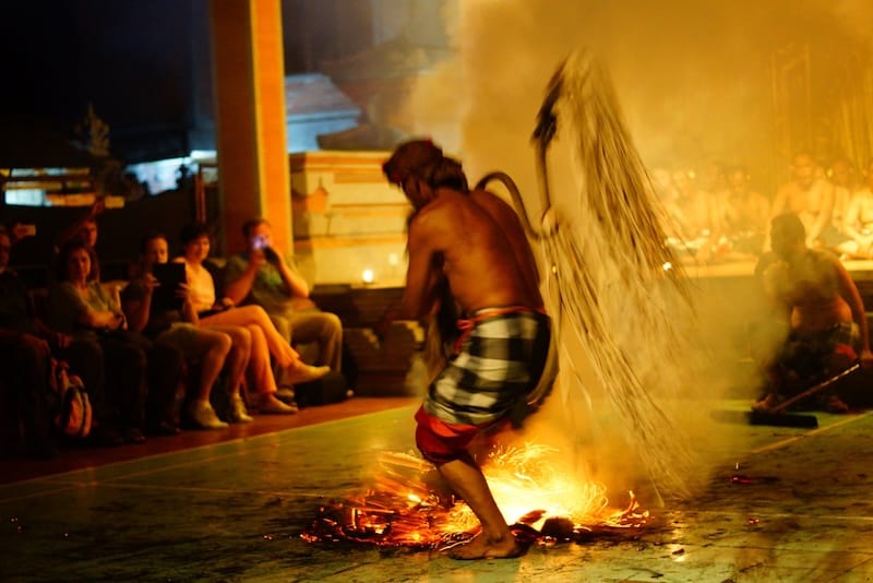 Balinese fire dance in Ubud, Bali with sparks flying everywhere as a man performs 
