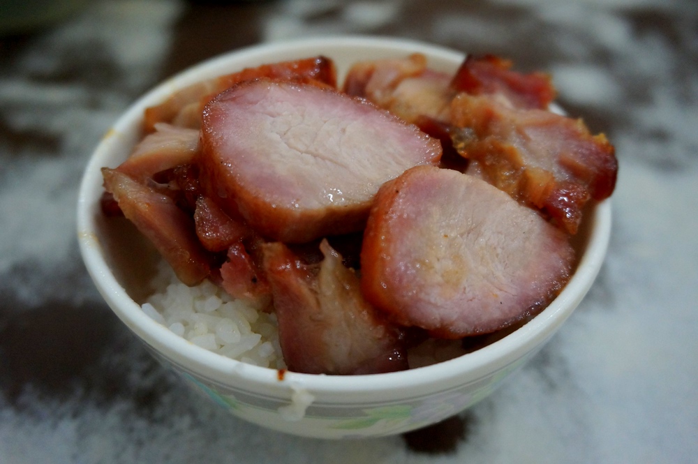 Barbecued pork rice or BBQ pork rice with lean cuts of meat in Hong Kong served in a bowl macro details 