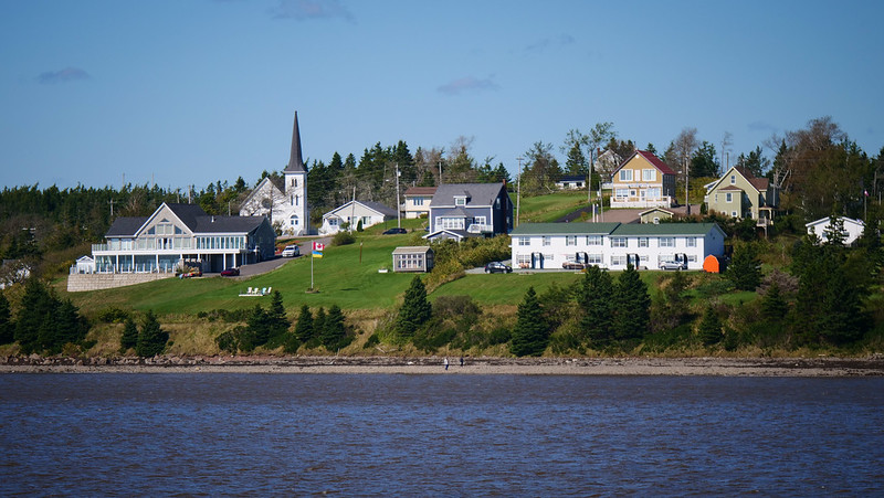 Beautiful views of the village of St. Peters from Battery Provincial Park with cute homes and cathedral on display 