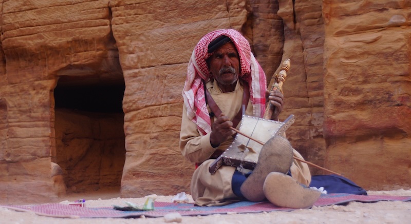 Bedouin man playing an instrument at Petra, Jordan 