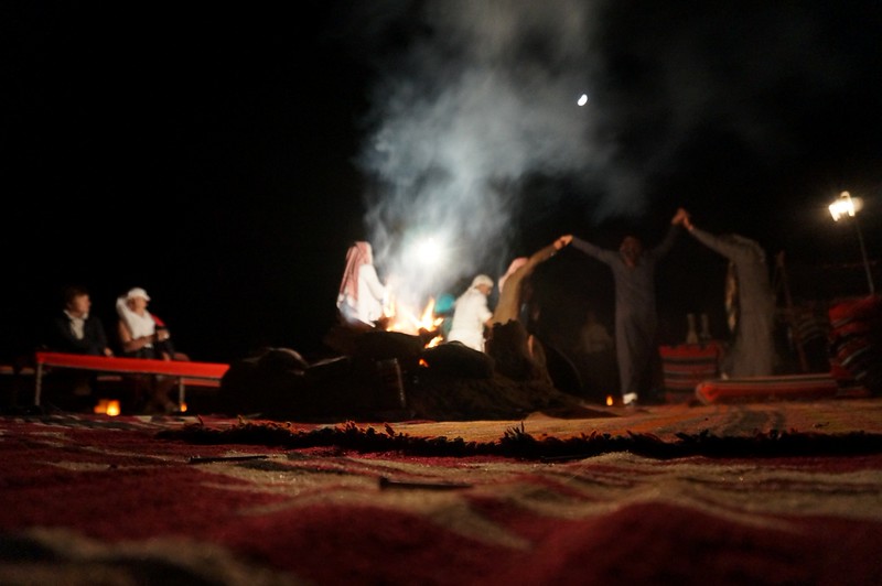 Bedouins playing music and dancing at our camp in Wadi Rum, Jordan as fire keeps us all warm and provides light for our nightlife cultural experience