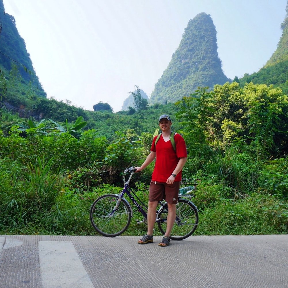 Biking Yangshuo karst mountains in China is a happy Nomadic Samuel enjoying rural countryside scenery