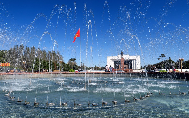 Bishkek water-fountain views at the main square with a national flag and monument in the background in Kyrgyzstan