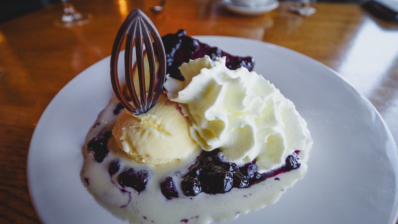 Blueberry cake with vanilla ice cream and whipped cream for a decadent dessert at Salty's in Halifax 