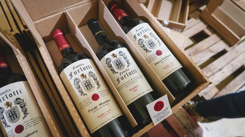 A box of Familia Furlotti Malbec wines from Bodega Furlotti in Mendoza, Argentina. The elegant labels display the family crest and vintage year, highlighting the region’s winemaking heritage and the premium quality of these bottled selections