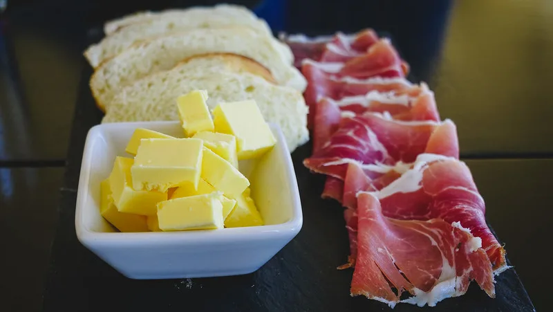 Breakfast spread of bread and butter and deli meats at Bodegas Lopez Tour in Mendoza