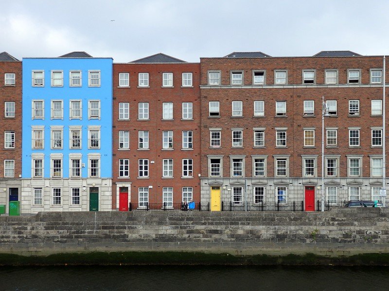 Bright doors (green, red, yellow, red) and a random blue building add some colour to Dublin, Ireland on a grey day