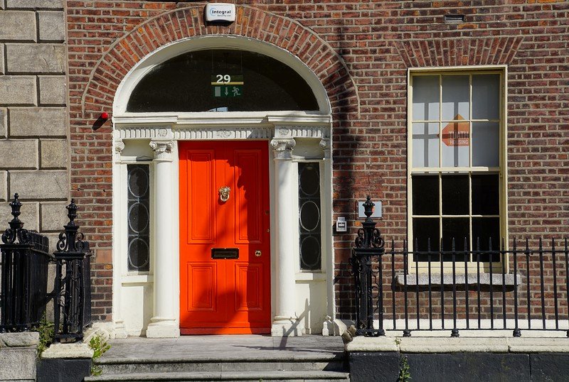 Bright Georgian style doors in Dublin, Ireland with column facade and archway on a brick building