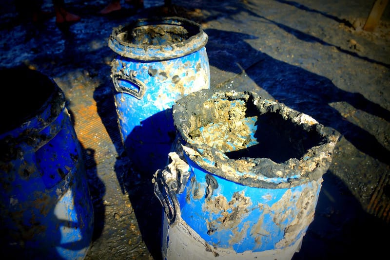 Bucket of black mud full of minerals located at the Dead Sea in Israel