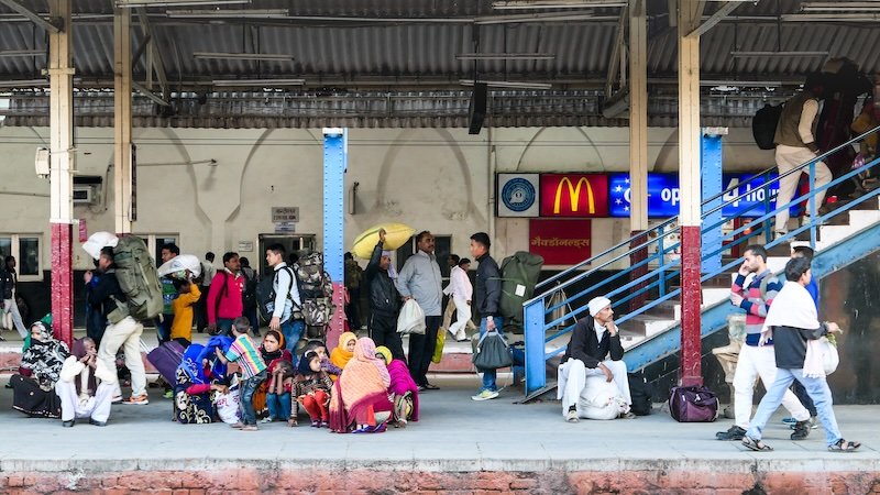 Busy train station scene in India with a bustling hive of activity at all times 