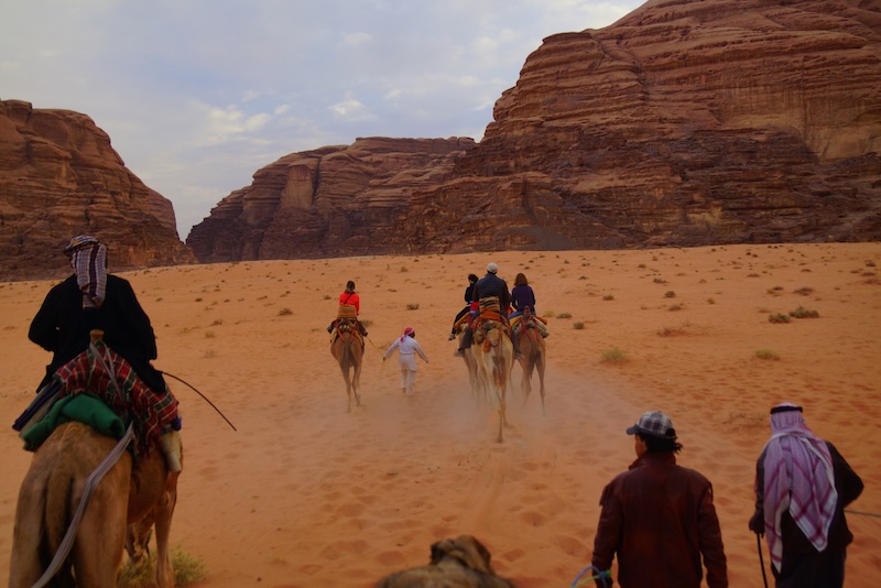 Camel riding scene in Wadi Rum desert in Jordan 