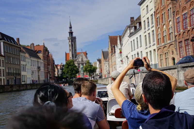 Canal boat tour in Bruges, Belgium views from the boat level on the water Canal boat tour in Bruges, Belgium views from the boat level on the water
