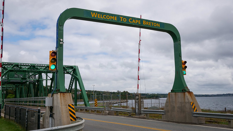 Canso Causeway welcome sign in Southern Cape Breton Island in Nova Scotia with green light