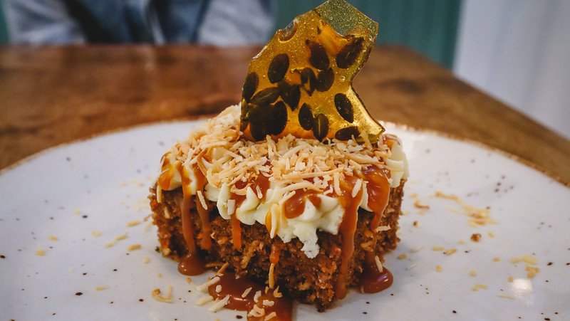 Carrot cake with cream cheese icing, shredded coconut, and pumpkin seed brittle. Does it get any better than this for dessert on a Halifax food tour?