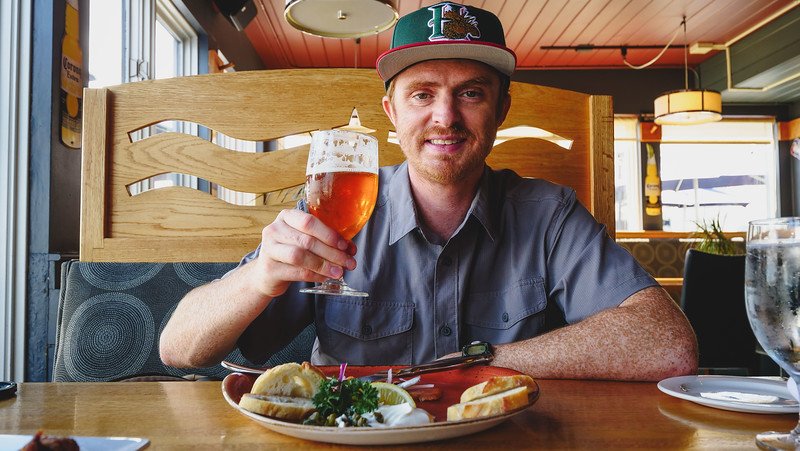 Casual seafood lunch at Salty's in Halifax with a happy Nomadic Samuel enjoying a pint of beer to wash it all down 
