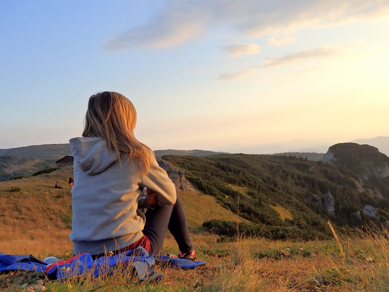 Catching more sunsets in Romania on our epic hike with That Backpacker Audrey Bergner admiring it after a long day of hiking to the top