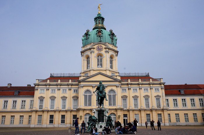 Charlottenburg Palace in Berlin, Germany, featuring its ornate Baroque façade, central dome, and equestrian statue in front, highlighting the city’s only surviving royal residence and a key destination for history and culture lovers