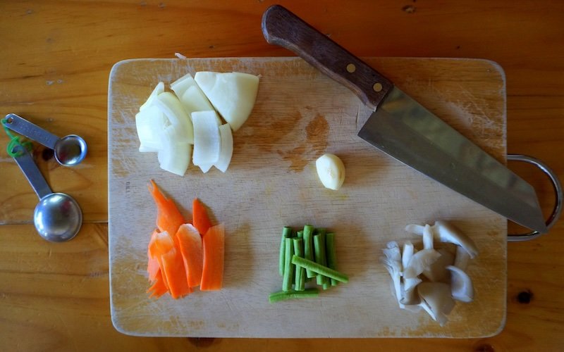 Chopping Thai vegetables on a cutting board in Chiang Mai, Thailand 