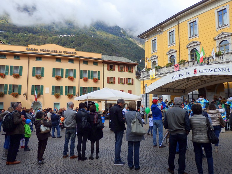 Citta di Chiavenna in Italy town square with pedestrians enjoying all of the festivities on offer for this vibrant meat festival celebration