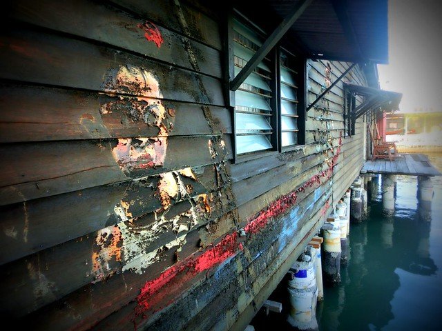 Street art mural on the wooden exterior of a stilt house at the Clan Jetties in Georgetown, Penang, Malaysia, blending heritage and urban culture