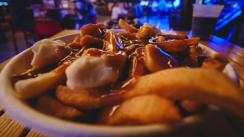 Classic poutine at The Stubborn Goat Beer Garden in Halifax, Nova Scotia with trademark gravy, giant chunks of cheese curds and thick fries